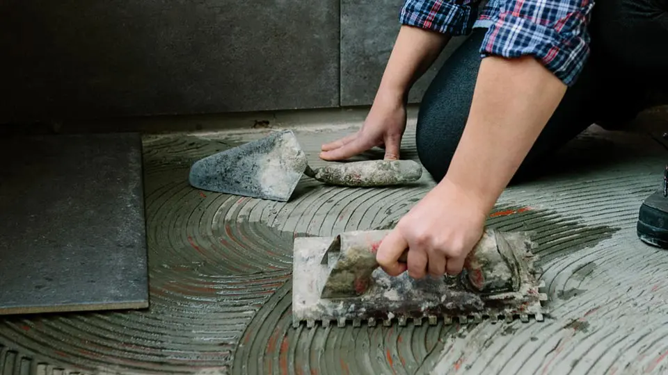 Homem reformando piso de uma casa. Foto: Adobe Stock